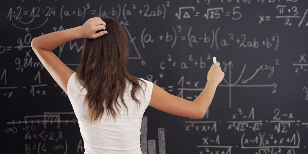 young-woman-looking-math-problem-blackboard-min-scaled-e1604065611100-1024x512